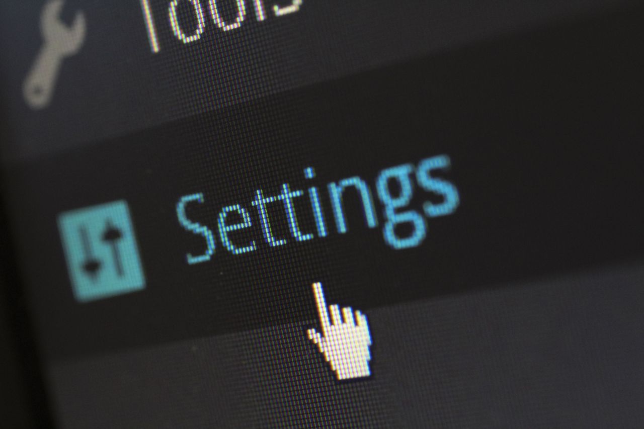 Services A close-up photo of a computer screen showing the settings button with a cursor hovering over it.