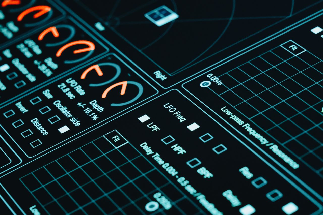 Services Close-up of a digital interface showcasing futuristic graphs and data analytics in low light.