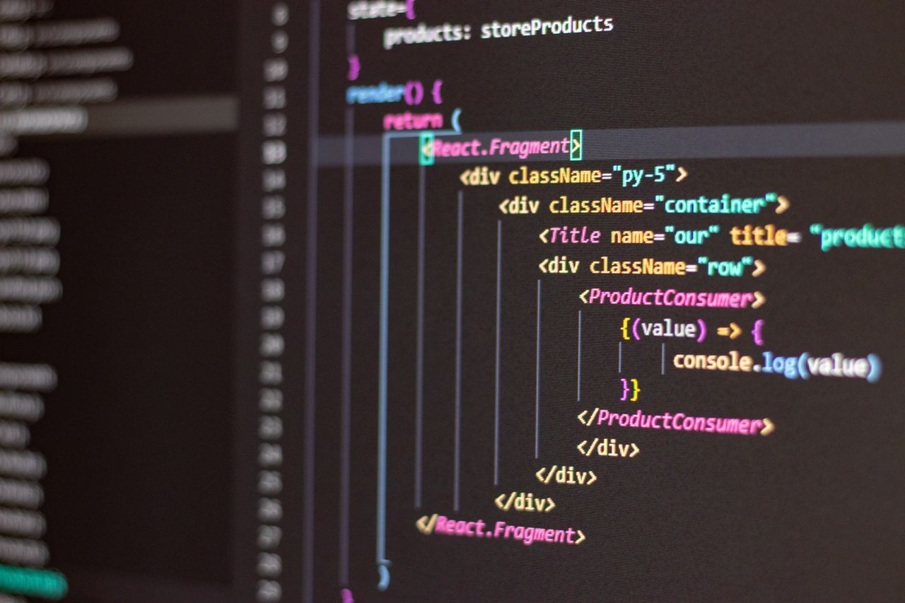 Home Close-up of HTML and JavaScript code on a computer screen in Visual Studio Code.